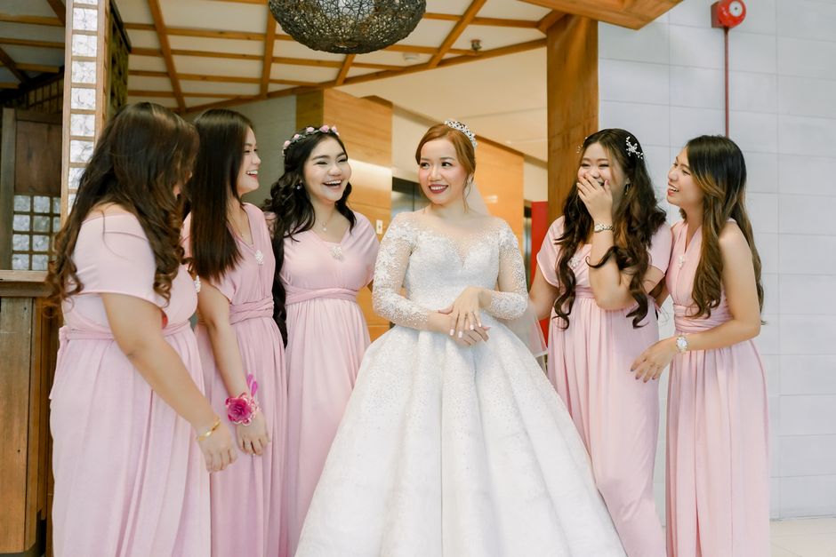 Joyful bride and bridesmaids preparing for the ceremony